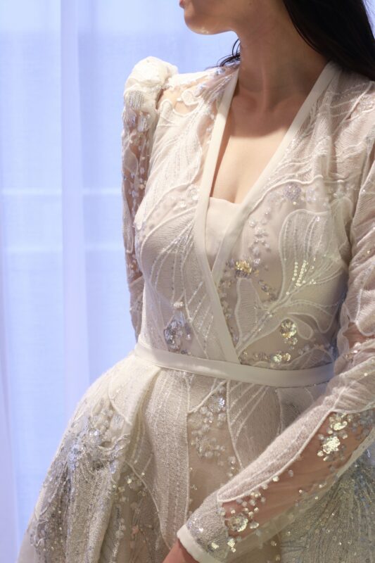 トレンドに敏感なおしゃれ花嫁にお召いただきたいのは、上品に空いた胸元のVネックと昨年からトレンドのパフショルダーのデザインが印象的なエリーサーブ　ブライドのウェディングドレスです