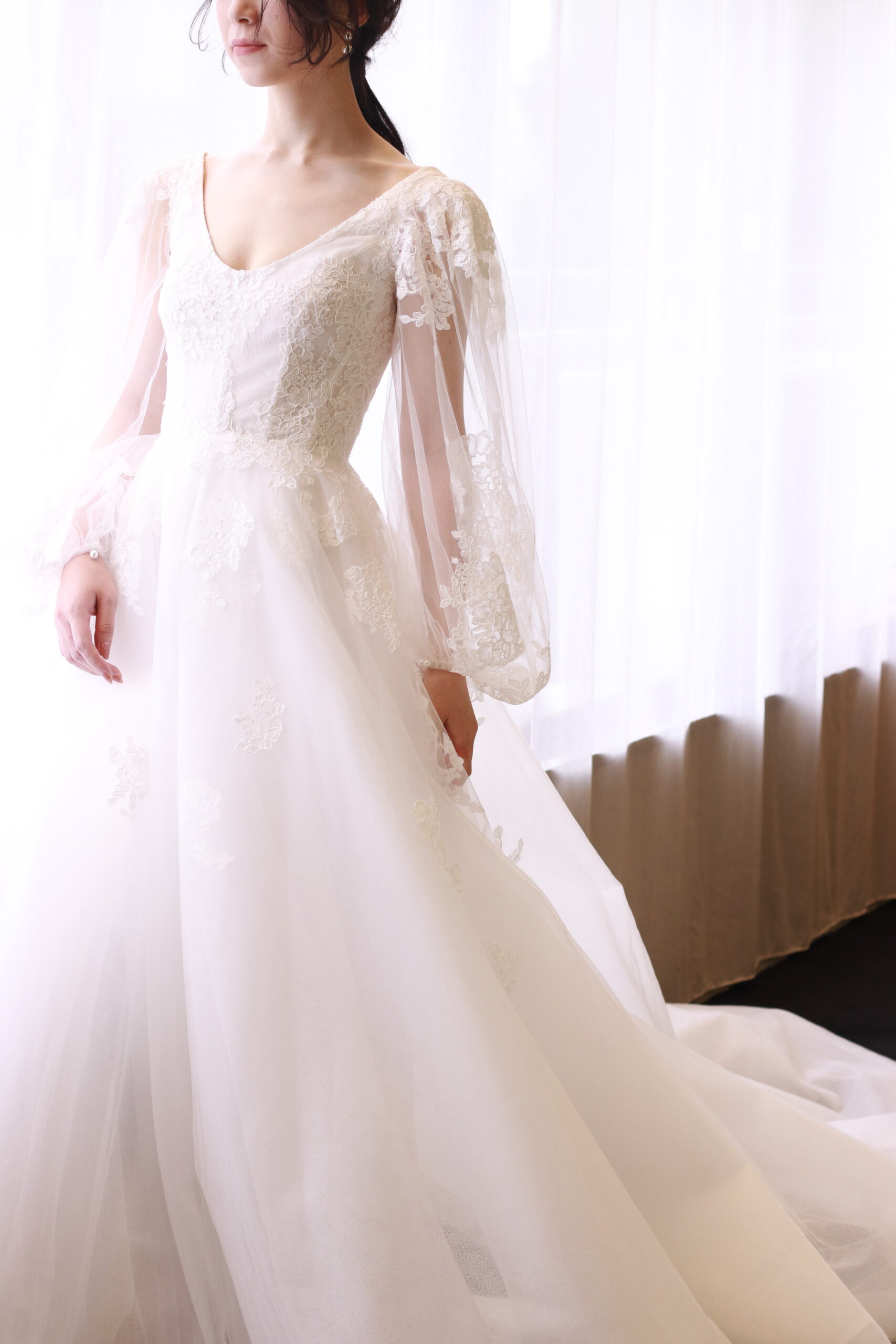 モニークルイリエの新作ウェディングドレスはAラインにロングスリーブの上品なデザインが特長のウェディングドレスです。コードリバーレースの施されたウェディングドレスは柔らかな花嫁姿を演出いたします。